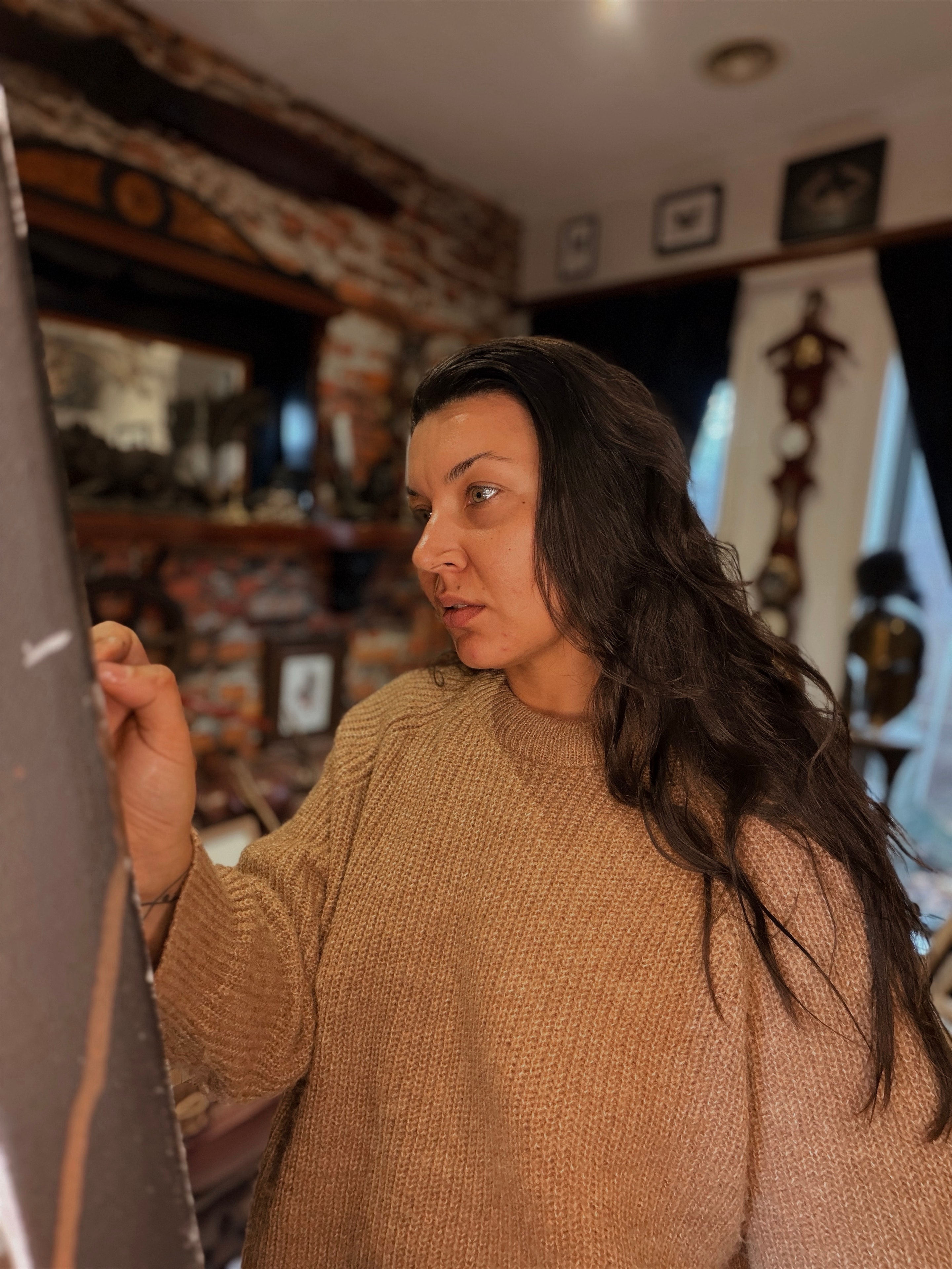 Artist holding a paintbrush in the studio