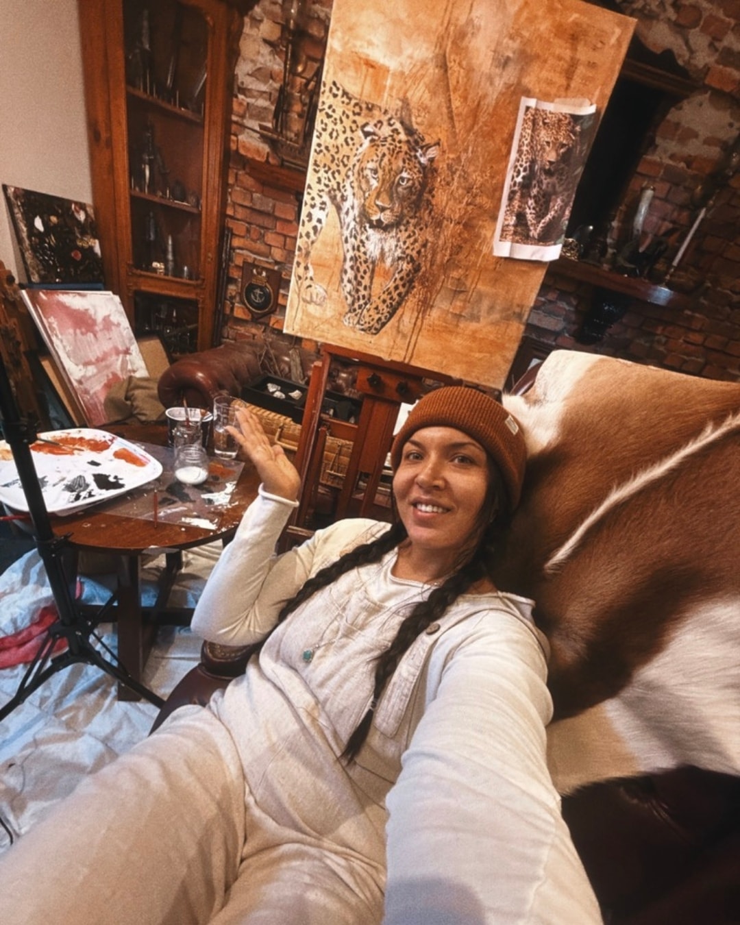 Victoria Lyn at her studio desk with sketchbook and paints